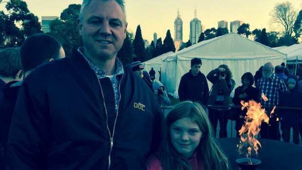 Peter Theisz and his daughter Holly warm up after dawn service.