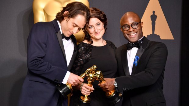 Producers Jeremy Kleiner, left, and Adele Romanski and director Barry Jenkins pose after Moonlight was awarded best picture.