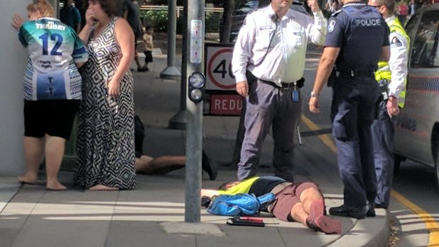 A man was left lying on the ground "with his eyes fluttering" in South Brisbane after the assault. 