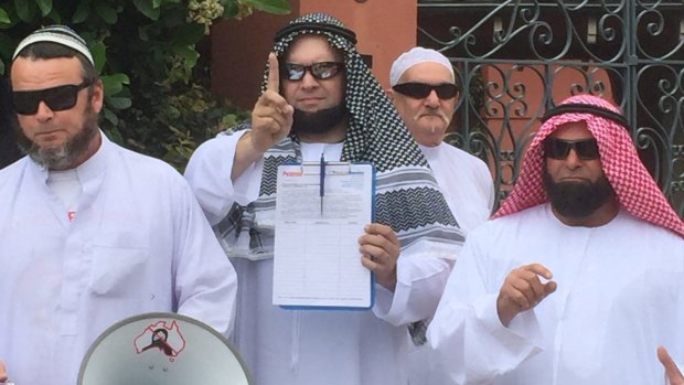 Nick Folkes (pictured left) and fellow representatives from the Party For Freedom protest outside Malcolm Turnbull's home.