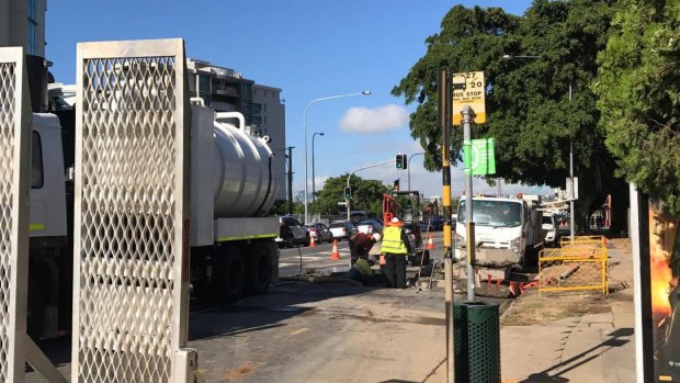 Queensland Urban Utilities workers fix a burst water main on Kingsford Smith Drive.