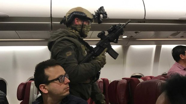 Heavily armed police storm a Malaysian Airlines flight in Melbourne in June after waiting 90 minutes.