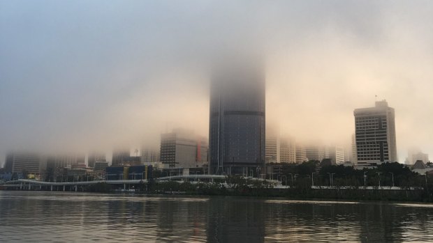 The Brisbane CBD shrouded in fog on Sunday morning.
