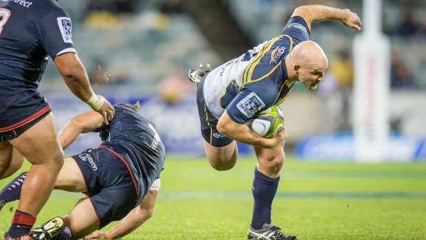 Hooker Stephen Moore of the ACT Brumbies stumbles in the slippery conditions.