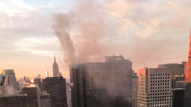 Smoke rises from Trump Tower in New York after a fire in the heating and air conditioning system of the building.
