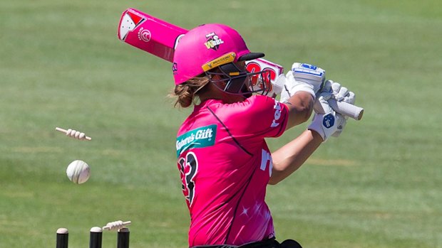 Angela Reakes of the Sixers is bowled by the Heat's Delissa Kimmince.