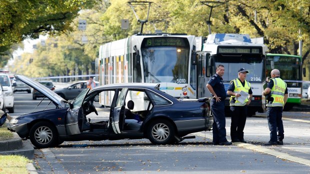 The crash on Royal Parade has left a woman fighting for her life.