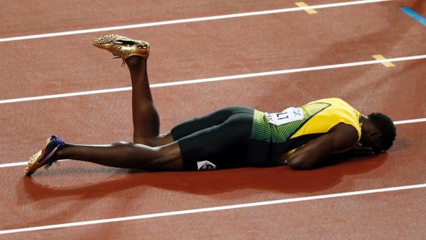 Dramatic finale: Usain Bolt lies on the track after pulling up injured in the final leg of the 4x100m relay at the World Athletics Championships.