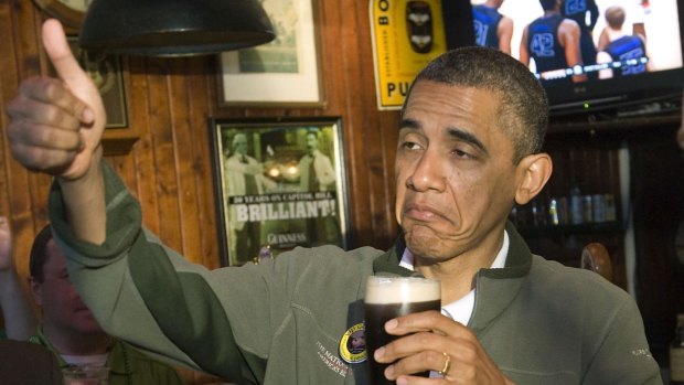 US President Barack Obama celebrates St. Patrick's Day with a Guinness at the Dubliner Irish pub in Washington, March 17, 2012.  