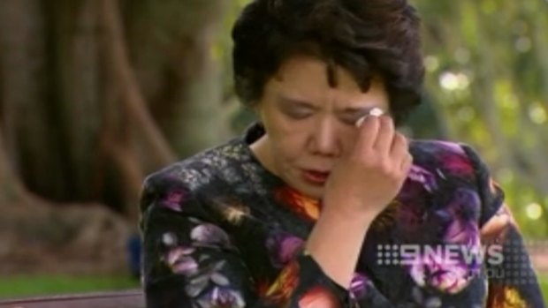 Selina Cheng dabs her eyes as she speaks about her murdered husband.