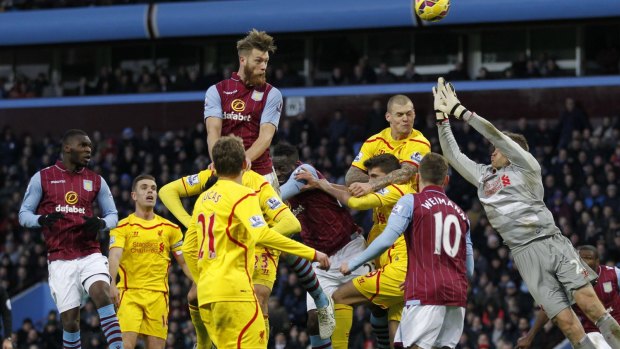 Hotly contested: Aston Villa defender Nathan Baker rises for a header in the Liverpool penalty box.