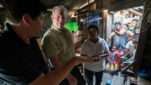 Al Gore (second from left) in Tacloban City, Philippines, discussing the effects of 2013's devastating Typhoon Haiyan.