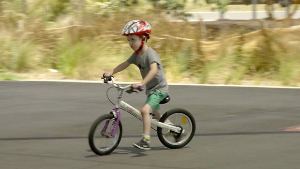 Five-year-old Toby on a balance bike. Unlike most bicycles used by younger children, it doesn't have pedals. 