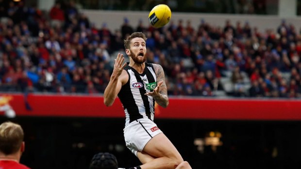 Jeremy Howe of the Magpies marks the ball over Tom McDonald of the Demons.