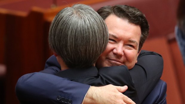 Senators Dean Smith and Penny Wong hug after speaking on the Marriage Amendment Bill on Thursday.