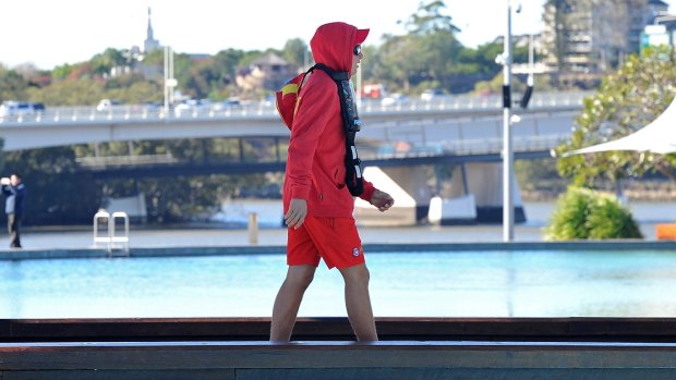 A Lifesaver at the pools at Southbank rugged up as cold weather hits south-east Queensland.