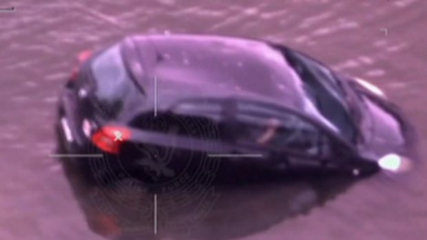 Dramatic vision shows officers rushing into the water and swimming towards the sinking car.