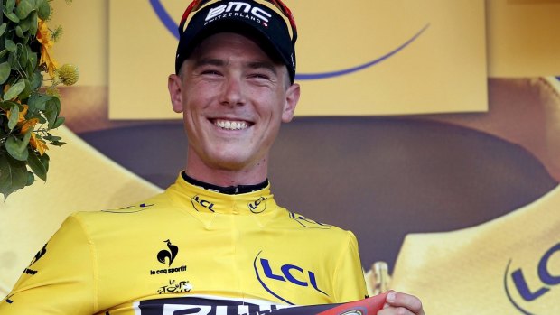 Aussie Rohan Dennis proudly wears the race leader's yellow jersey on the podium after winning the first stage of the Tour de France. 