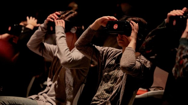 Audience members wearing VR headsets for playwright Jack Lowe's <i>Frogman</i>.