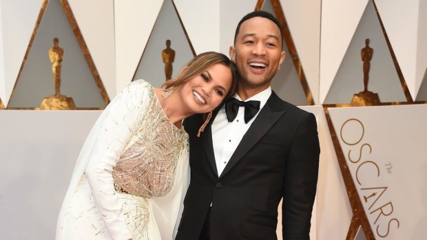 Chrissy Teigen,and John Legend arrive at the Oscars this year.