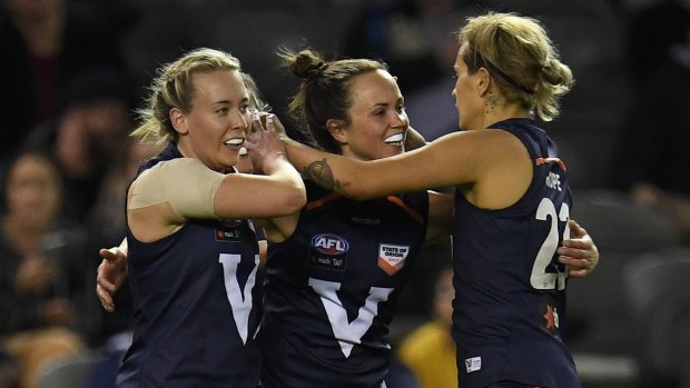 AFLW in good state: Lauren Arnell, Daisy Pearce and Moana Hope celebrate a Big V goal.