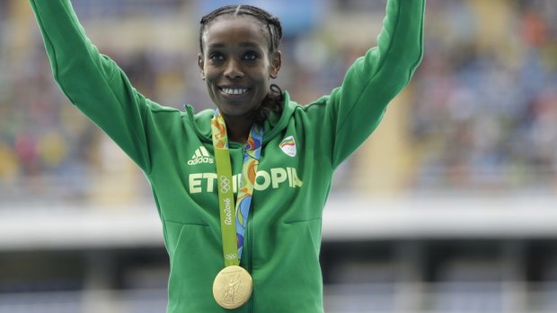 Smashed the world record: Ethiopia's Almaz Ayana celebrates winning the gold medal.