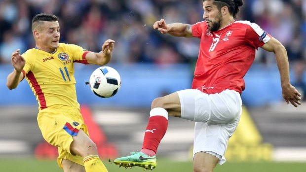 Romania's Gabriel Torje, left, goes for a 50-50 with Switzerland's Ricardo Rodriguez.