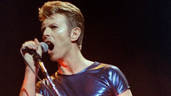 Singer David Bowie launches into his first solo song of a six-week concert tour of North America he performs with the band Nine Inch Nails at the Meadows Music Theatre in Hartford, Connecticut in 1995.