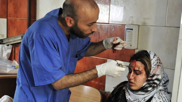 An injured victim of the triple blast in Sayyida Zeinab is treated in hospital on Sunday..