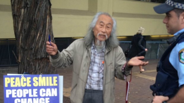 Self-styled "peace activist" Danny Lim was fined for offensive behaviour after brandishing a sign targeting Prime Minister Tony Abbott.