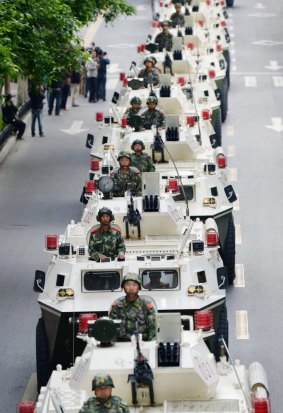 Paramilitary policemen parade in Urumqi in May, after authorities announced a year-long anti-terrorism crackdown.