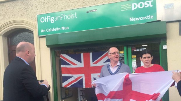 Irish post office manager Billy Cameron, with colleague Marie Murphy, put up a Union Jack in his  Newcastle shop window and displayed a St George Cross flag as a small step towards reconciliation.