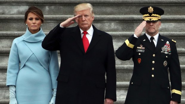 President Donald Trump with first lady Melania Trump and Major General Bradley Becker review troops in Washington.