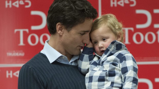 Trudeau holds his son Hadrien during a campaign event in Iqaluit, Nunavut.