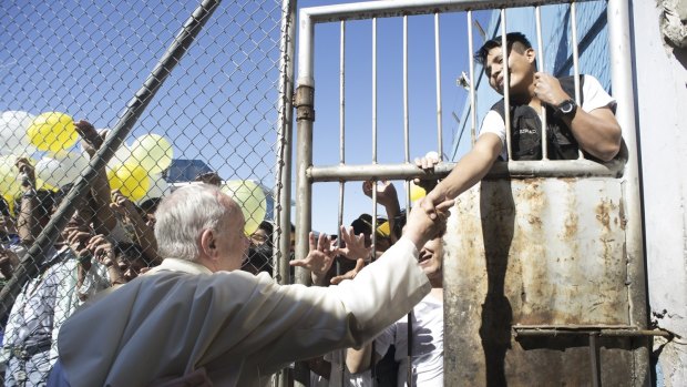 Reaching out to Pope Francis during his visit at the prison of Palmasola in Santa Cruz, Bolivia, last week.
