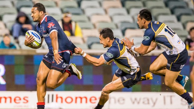 Rebels winger Sefanaia Naivalu (left) shows his power during a game against the Brumbies in April.