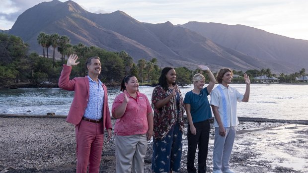 Staff welcome guests in a scene from The White Lotus.