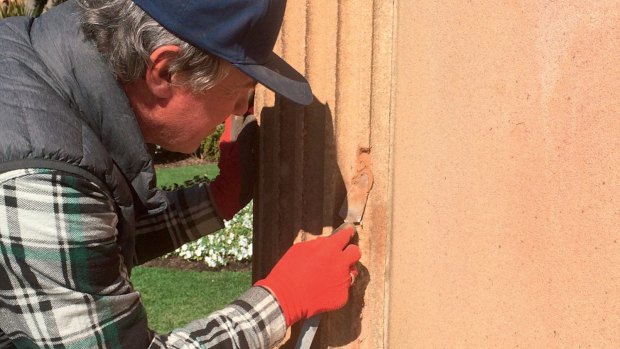 The stonemason repairs damage to the Lysicrates Monument in the Royal Botanic Gardens.