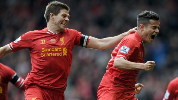 Liverpool's Philippe Coutinho, right, celebrates after scoring the winning goal.