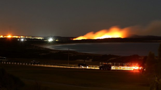 A bushfire burns near the Kurnell oil refinery overnight.