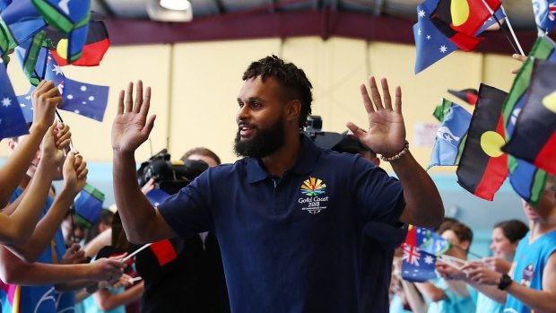 Commonwealth Games ambassador Patty Mills greets high school students on the Gold Coast.