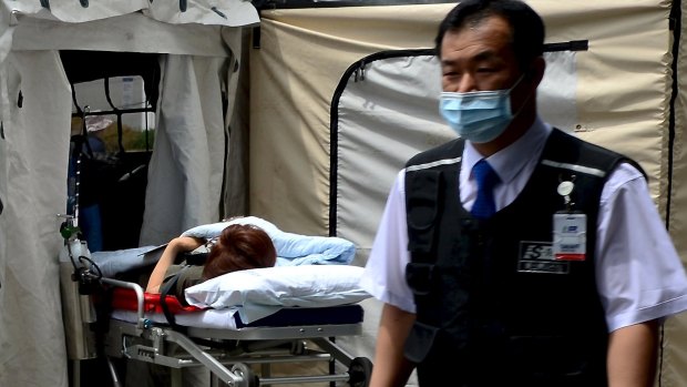 A woman believed to be infected with MERS lies on a stretcher in quarantine in Seoul on Wednesday.