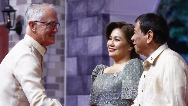 No word about atrocities. Prime Minister Malcolm Turnbull greeted by President of Philippines Rodrigo Duterte and Honeylet Avancena, his common-law wife.