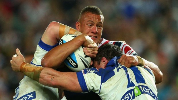 Kane Evans of the Roosters is tackled during Friday night's controversial game against the Bulldogs. 