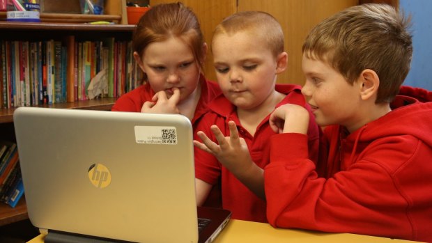 School children work off a computer at Darlington Public School. 