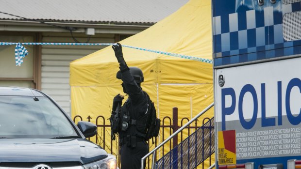 A police officer outside the house raided in  Braybrook.