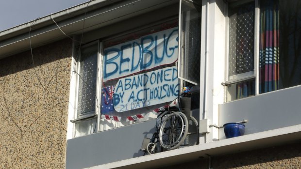 Protest sign in the window of the Northbourne Flats at Braddon.