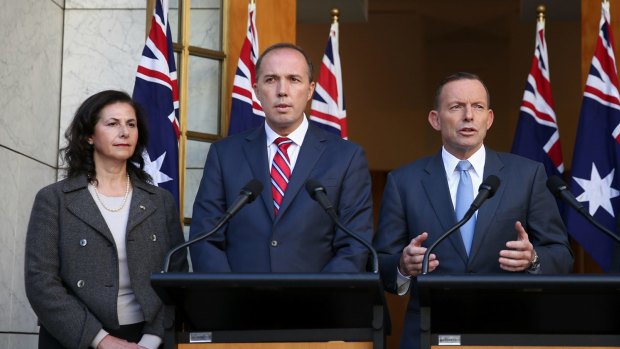 Senator Concetta Fierravanti-Wells, pictured with Immigration Minister Peter Dutton, and former prime minister Tony Abbott, has distanced herself from the rhetoric of Mr Abbott. 