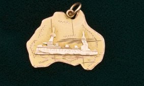 Nine carat  yellow and rose gold pendant in the shape of the map of Australia with a warship, c.1915 - $900