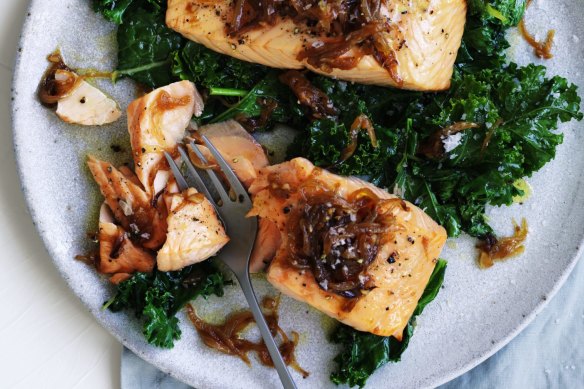 Quick, healthy dinner: Salmon fillets with caramelised onion and wilted greens.